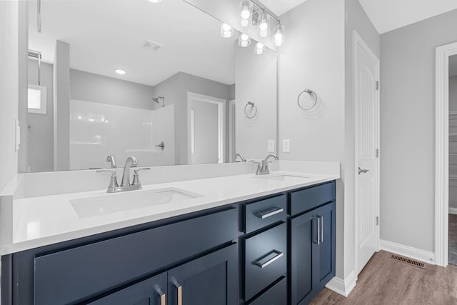 437 Friendly Ave, Nicholasville, KY 40356 - full bathroom with double vanity, wood finished floors, baseboards, a shower, and a closet