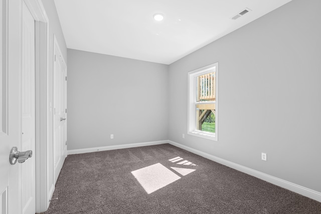 carpeted empty room with visible vents and baseboards