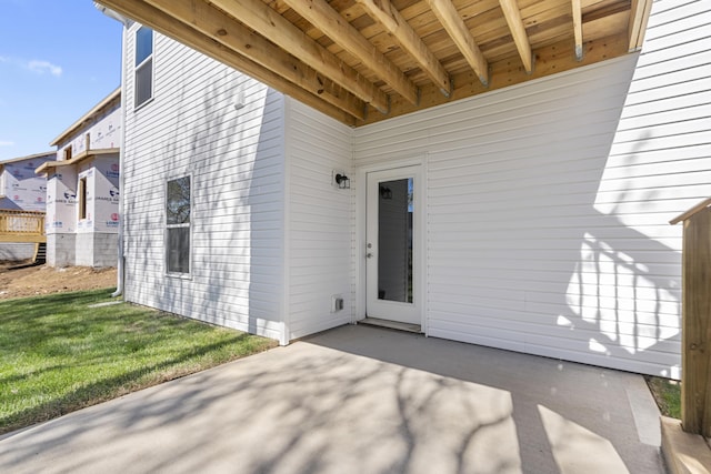 doorway to property featuring a yard and a patio