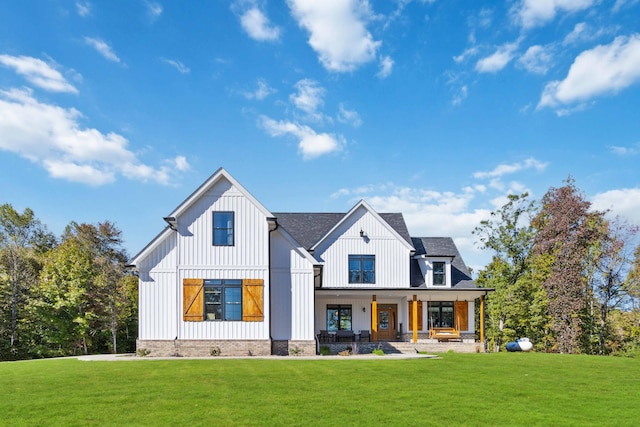 modern farmhouse style home featuring a front yard and a porch