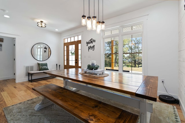 unfurnished dining area featuring french doors, light hardwood / wood-style floors, and a healthy amount of sunlight