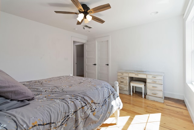 bedroom with ceiling fan and light hardwood / wood-style floors