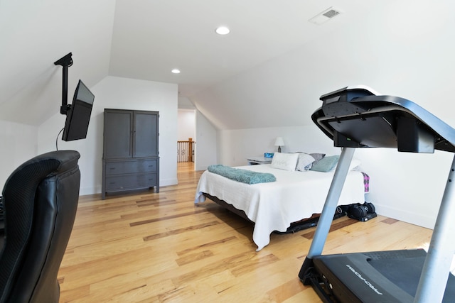 bedroom with lofted ceiling and hardwood / wood-style floors