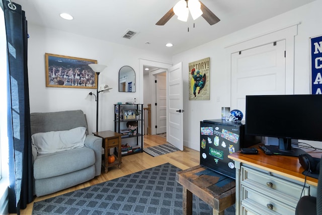 office with ceiling fan and light hardwood / wood-style flooring