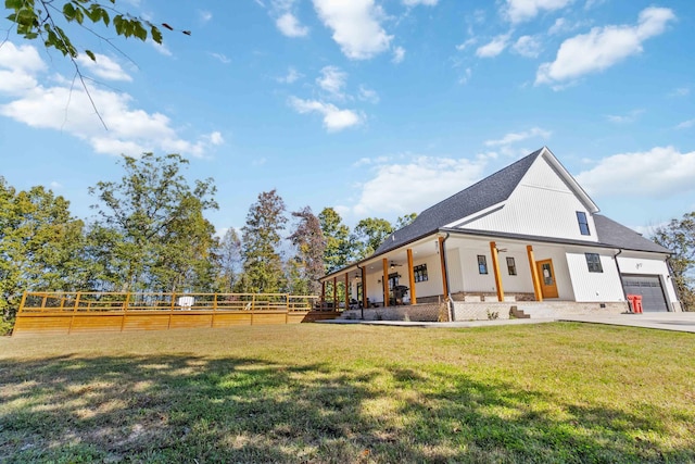 exterior space featuring a garage, a porch, and a front yard