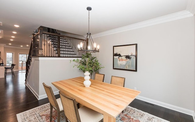 dining space featuring a chandelier, baseboards, stairway, dark wood finished floors, and crown molding