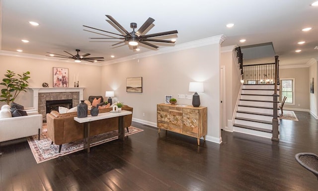 living area featuring crown molding, a fireplace, stairway, wood finished floors, and baseboards