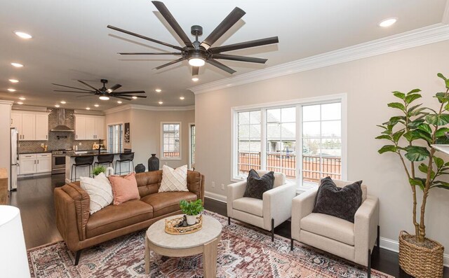 living room featuring ornamental molding, dark wood-style flooring, recessed lighting, and baseboards