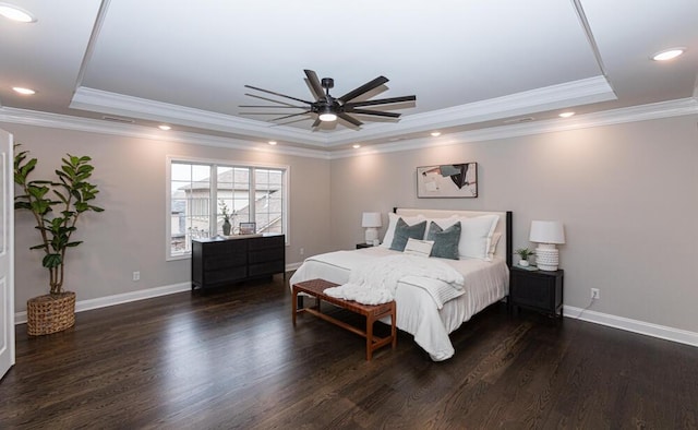 bedroom with baseboards, a tray ceiling, wood finished floors, and recessed lighting