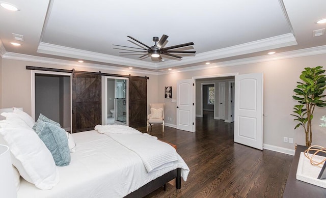 bedroom featuring a tray ceiling, a barn door, dark wood finished floors, and recessed lighting