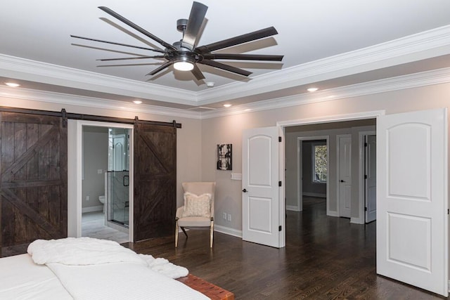 bedroom featuring recessed lighting, a barn door, ornamental molding, wood finished floors, and baseboards