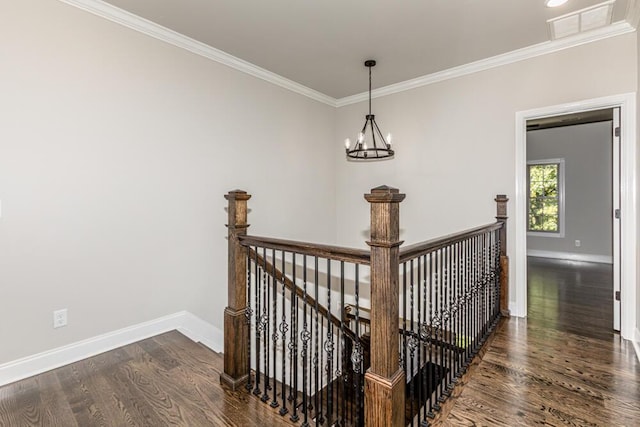 corridor featuring baseboards, visible vents, wood finished floors, and an upstairs landing