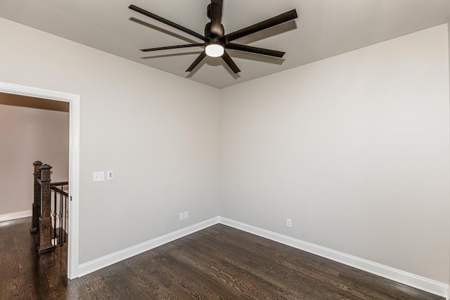 unfurnished room with a ceiling fan, dark wood-style flooring, and baseboards