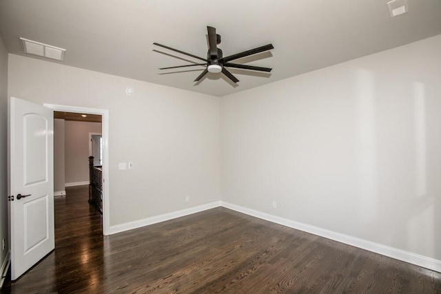 unfurnished room with baseboards, visible vents, ceiling fan, and dark wood-style flooring