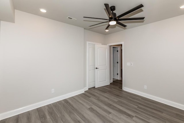 unfurnished room with recessed lighting, visible vents, ceiling fan, wood finished floors, and baseboards