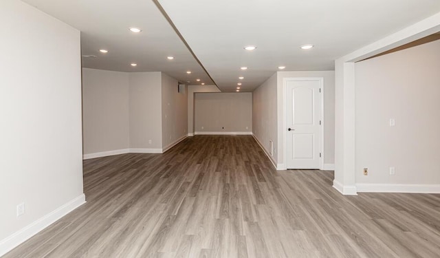 below grade area featuring recessed lighting, light wood-style flooring, and baseboards