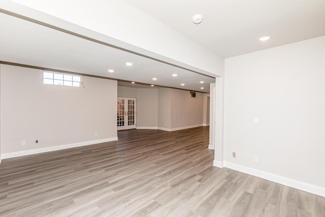 basement with light wood-style flooring, baseboards, and recessed lighting