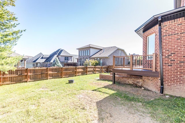 view of yard with fence and a deck