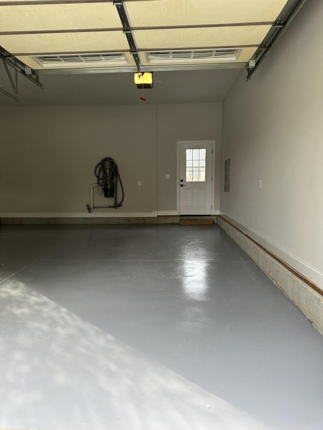 garage with electric panel and a garage door opener