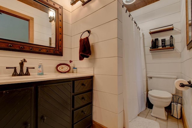 bathroom with tile patterned flooring, vanity, and toilet