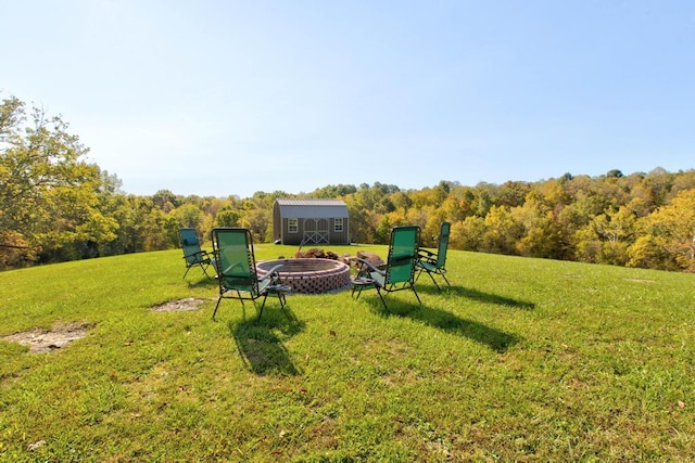 view of yard with a fire pit