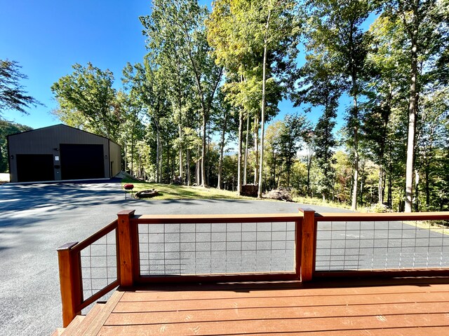 wooden deck with a garage and an outdoor structure