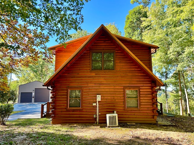 view of property exterior featuring an outdoor structure and a garage