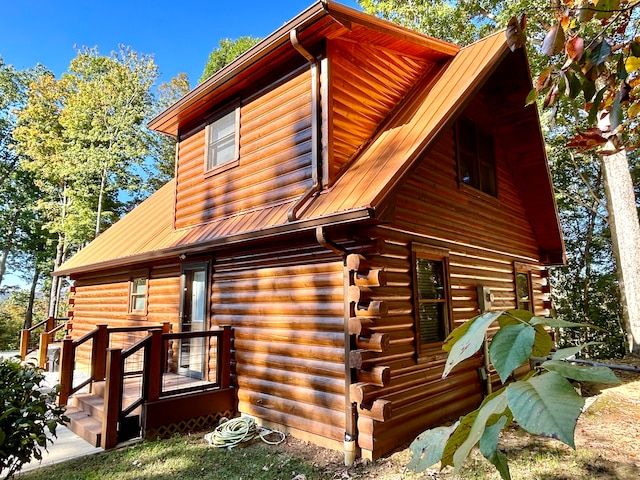 view of side of home with a wooden deck