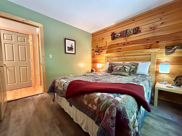 bedroom featuring carpet flooring and wooden walls