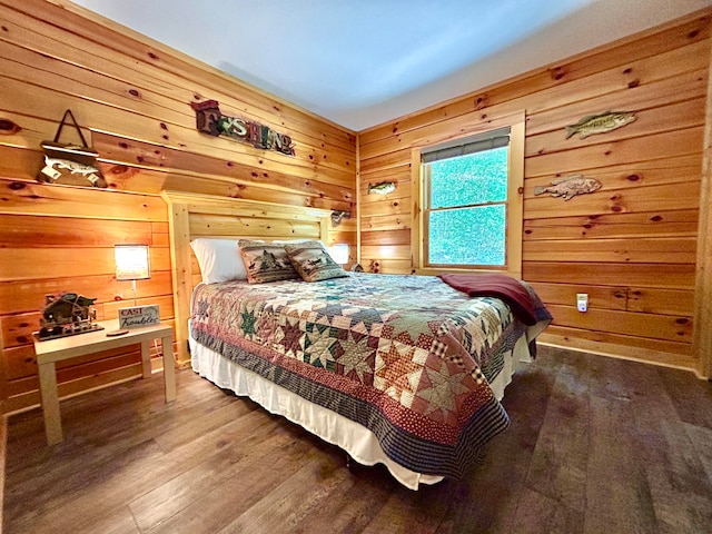 bedroom with wood walls and hardwood / wood-style floors