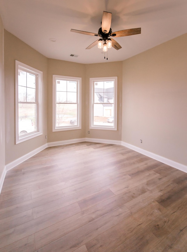 unfurnished room featuring ceiling fan and light wood-type flooring