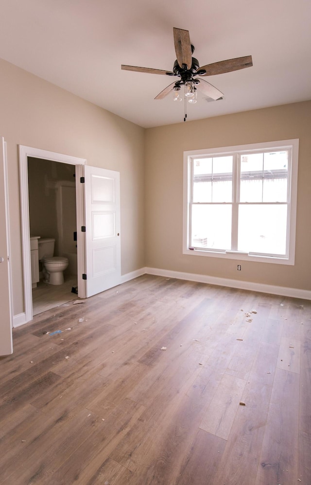 spare room with hardwood / wood-style floors and ceiling fan