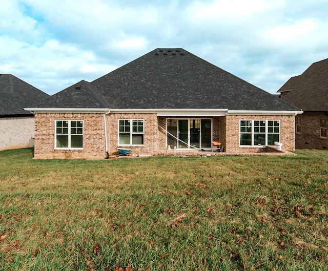 rear view of house featuring a yard