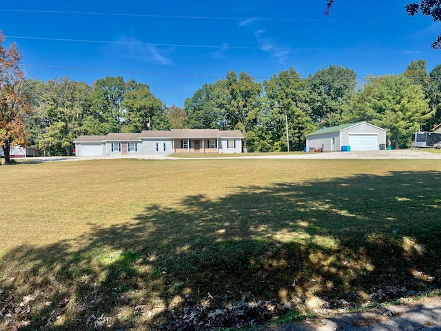 single story home with a front yard, a garage, and an outdoor structure