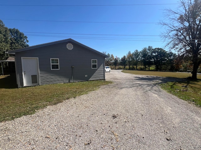 view of side of home featuring a lawn