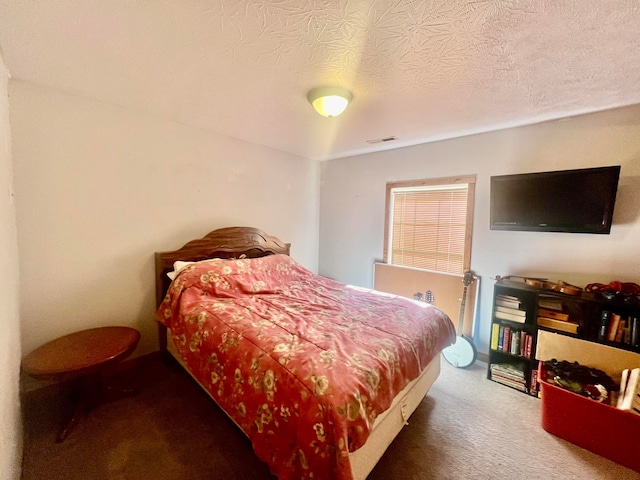 bedroom with carpet and a textured ceiling