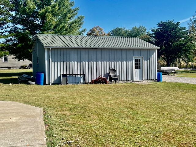 view of outbuilding featuring a lawn