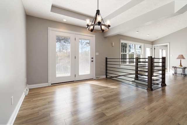 doorway with baseboards, recessed lighting, a notable chandelier, and wood finished floors