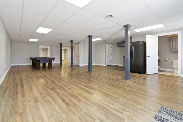 basement featuring light wood finished floors, stainless steel fridge with ice dispenser, pool table, and baseboards
