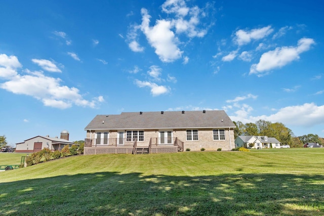 back of house featuring a yard and a deck