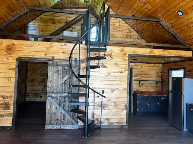 staircase featuring wood-type flooring, wooden ceiling, and wooden walls