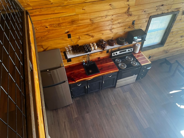 interior space featuring dark hardwood / wood-style floors, wood ceiling, and wooden walls