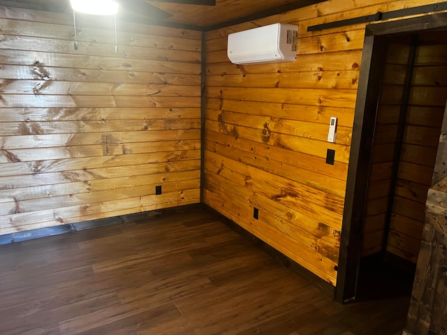 empty room featuring a wall mounted air conditioner, dark hardwood / wood-style flooring, and wooden walls