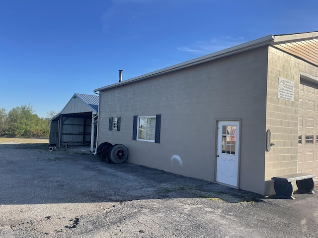 view of home's exterior with concrete block siding