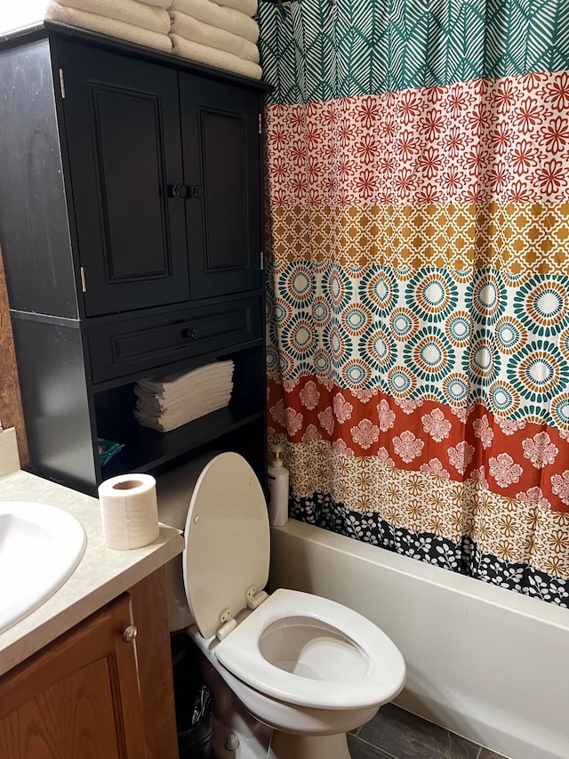 full bathroom with toilet, shower / bath combo with shower curtain, and vanity