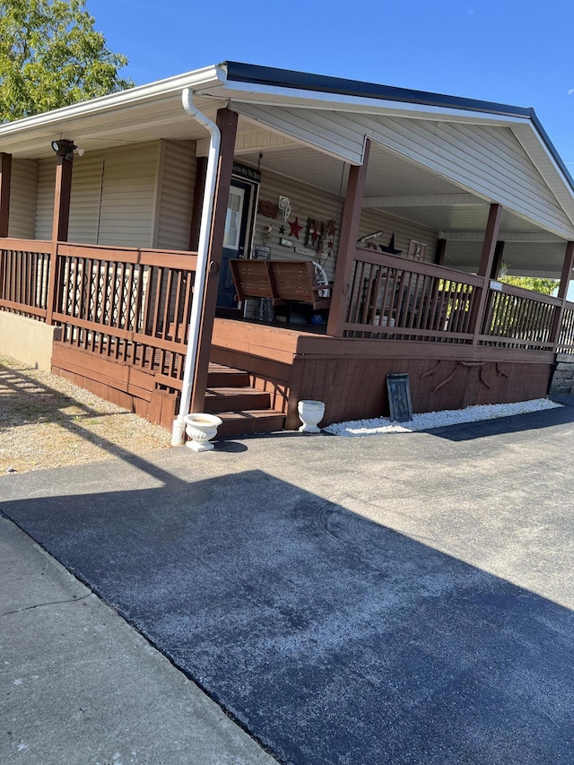 view of side of home with covered porch