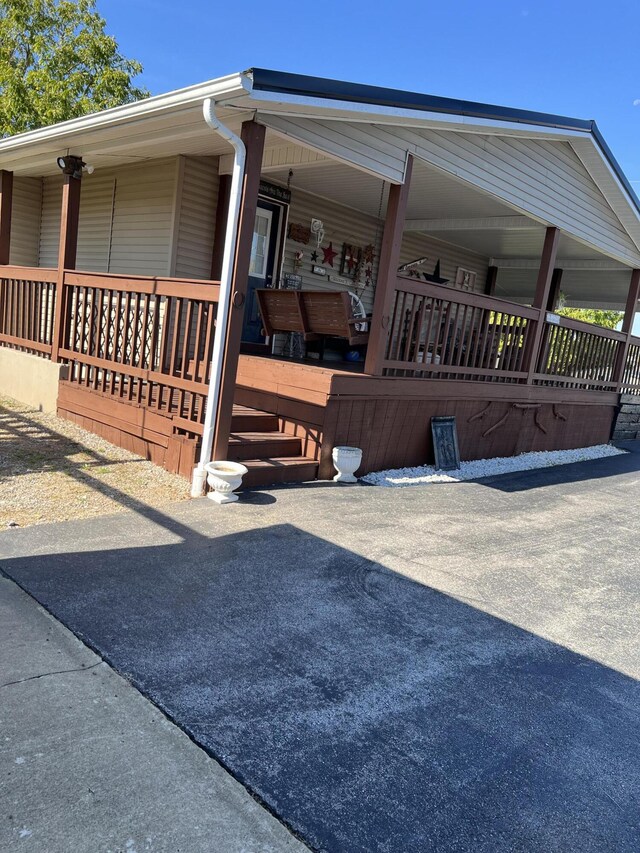 view of side of home with covered porch