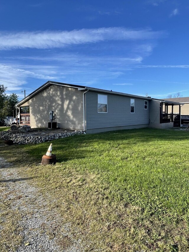 view of side of home featuring a lawn