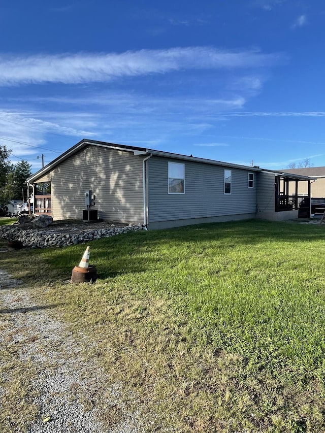 view of side of property with a lawn