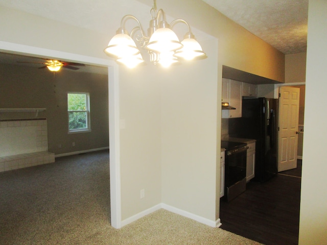 kitchen featuring dark colored carpet, ceiling fan with notable chandelier, black appliances, and a textured ceiling